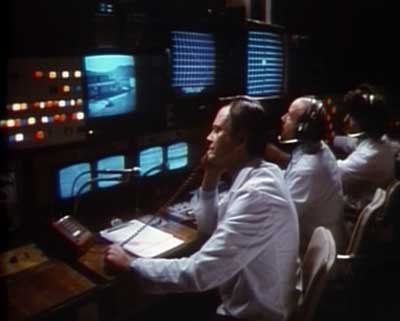 The hi-tech control room where they seem to be playing Qix. Parts image
